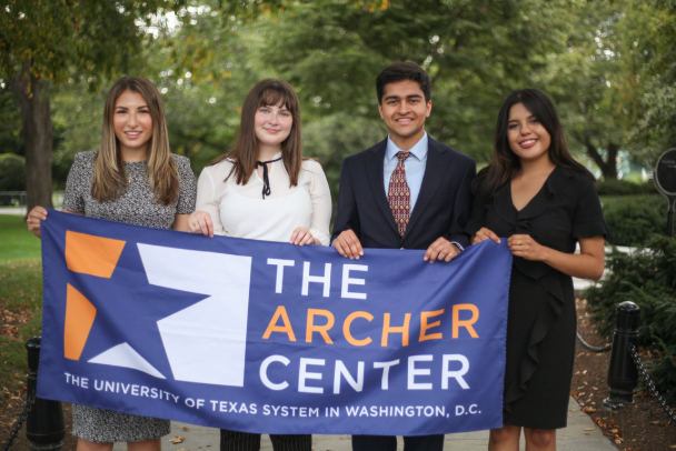 students holding archer center banner