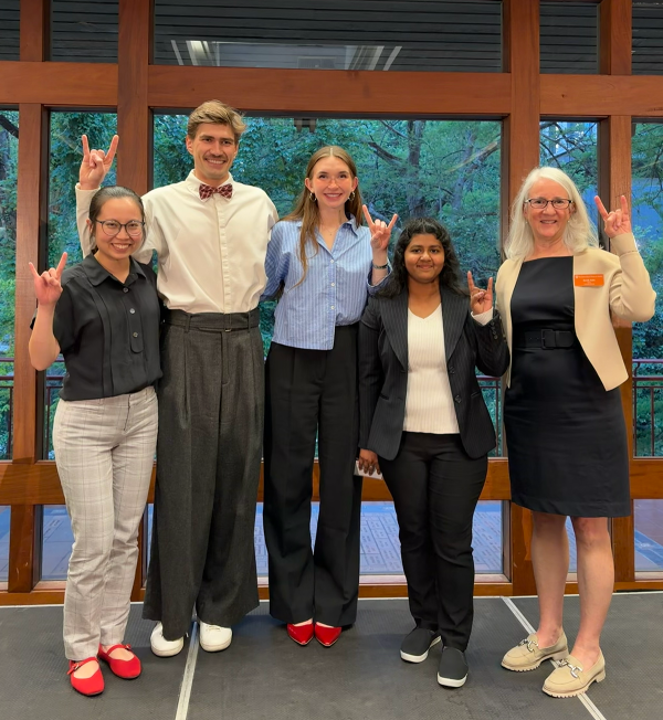 four doctoral students with graduate dean