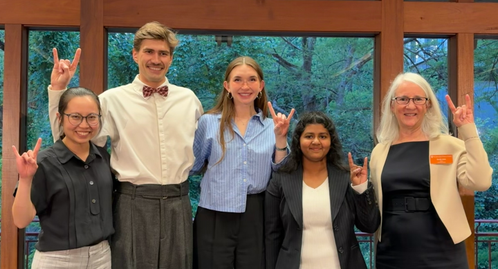 four doctoral students with graduate dean